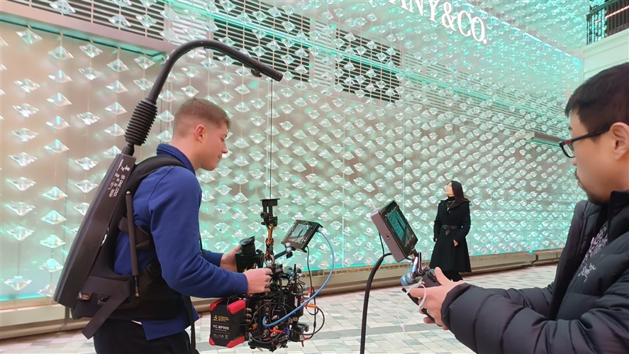 Retail-location production crew filming in a Shanghai luxury store
